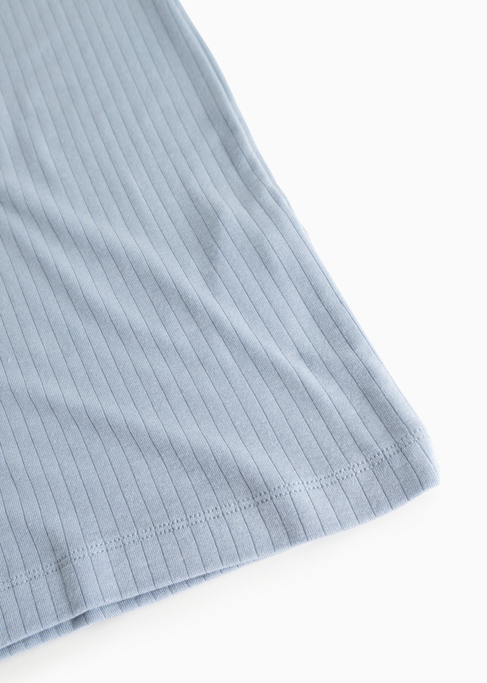 Light blue ribbed tank top, detailed edge and seam at the bottom.