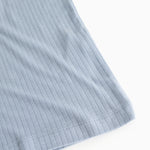 Light blue ribbed tank top, detailed edge and seam at the bottom.