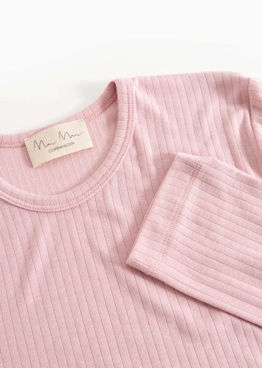 Pink evening dress with round neckline, ribbed fabric, and brand label at the collar.