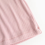 Pink evening dress with ribbed pattern, close-up of the bottom edge.