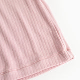 Pink evening dress with ribbed pattern, close-up of the bottom edge.