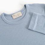 Light blue evening dress with round neckline, ribbed fabric and cuffed sleeves.