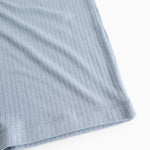 Light blue evening dress with ribbed texture and wide seam at the hem.