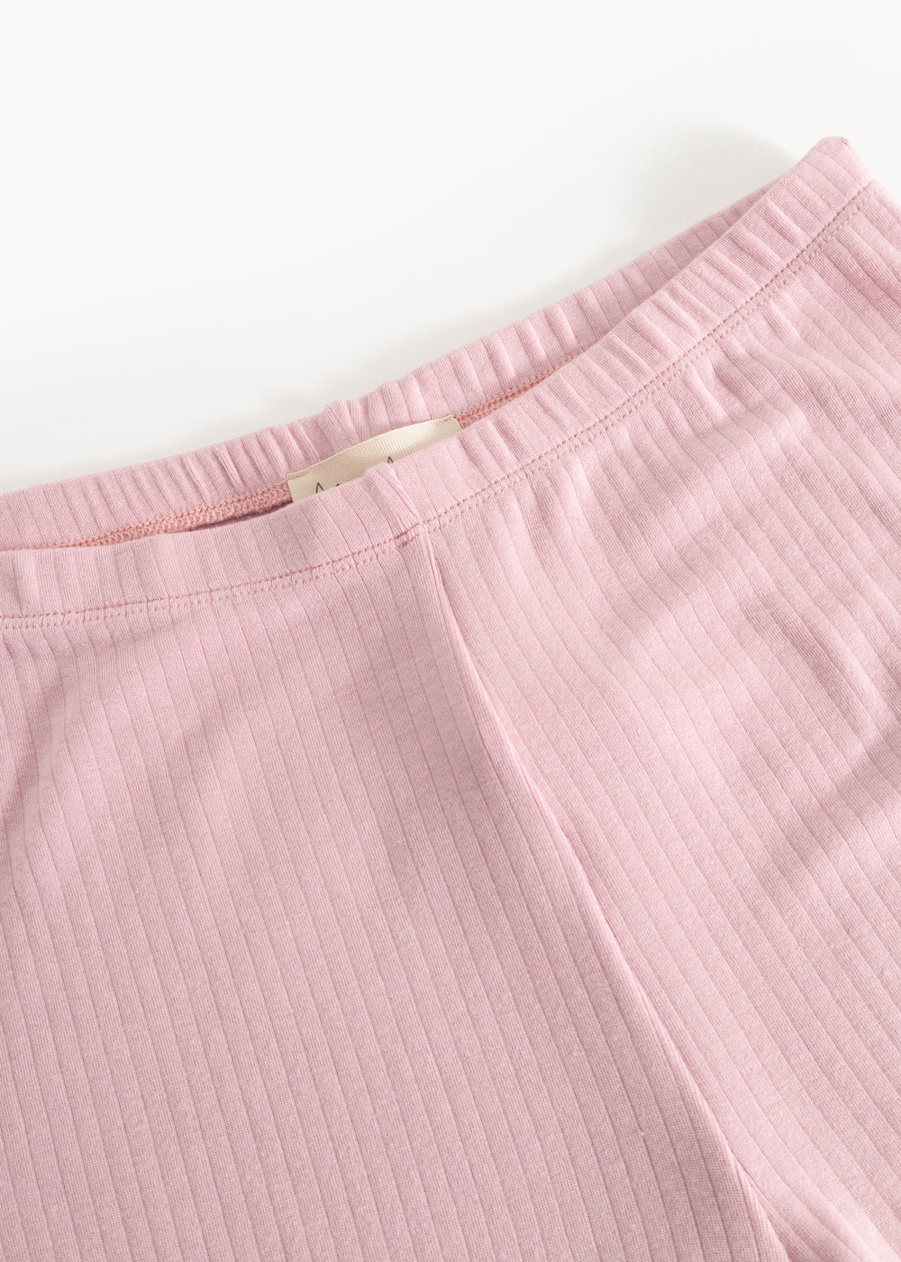 Pink pants with elastic waistband and visible inner seam at the waist.