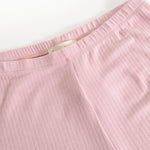 Pink pants with elastic waistband and visible inner seam at the waist.