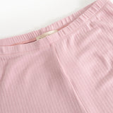 Pink pants with elastic waistband and visible inner seam at the waist.