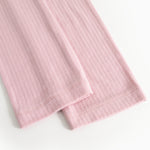 Pink pants with ribbed texture and folded edge at the leg opening.