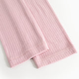 Pink pants with ribbed texture and folded edge at the leg opening.