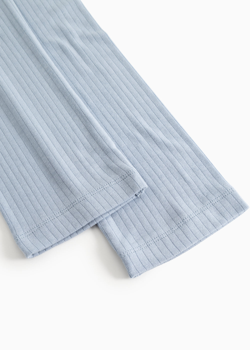 Light blue trousers with ribbed pattern and lower seam.