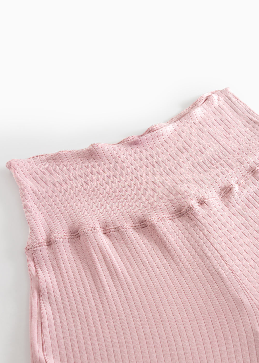 Pink ribbed pants with elastic waistband and seam at the waist.