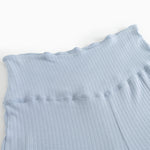 Light blue trousers with ribbed texture and wide elastic at the waist.