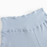Light blue trousers with ribbed texture and wide elastic at the waist.