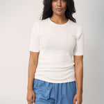 Woman wearing blue jeans with a loose fit and a white t-shirt