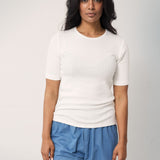 Woman wearing blue jeans with a loose fit and a white t-shirt