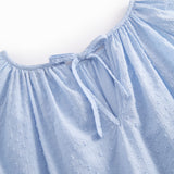 Light blue long-sleeved and loose-fitting blouse for women with an embroidered pattern.