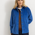 Blue shirt on model with collar and buttons, long sleeves and chest pocket.