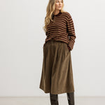 Brown bottom with pleated waist and wide folds, front snap closure.