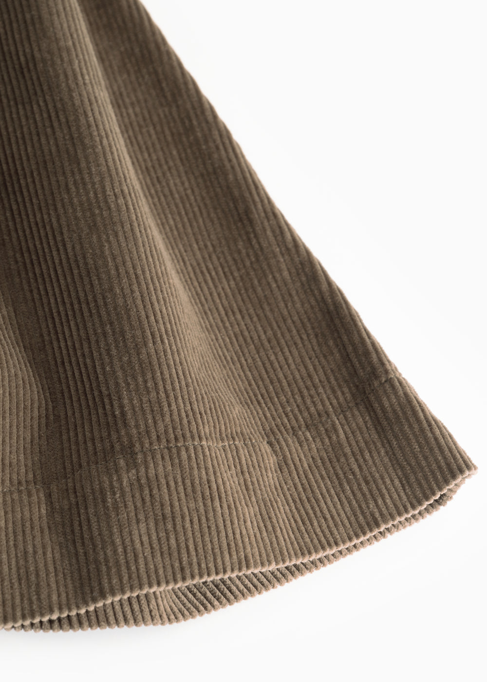 Brown lower part with ribbed edge and diagonal seam details at the bottom.