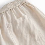 Beige shorts for women with side pockets, elastic at the waist, and a back pocket.