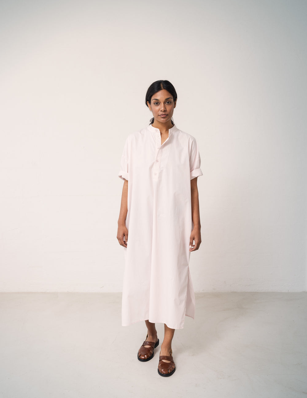 Woman wearing a bright red dress with a loose fit