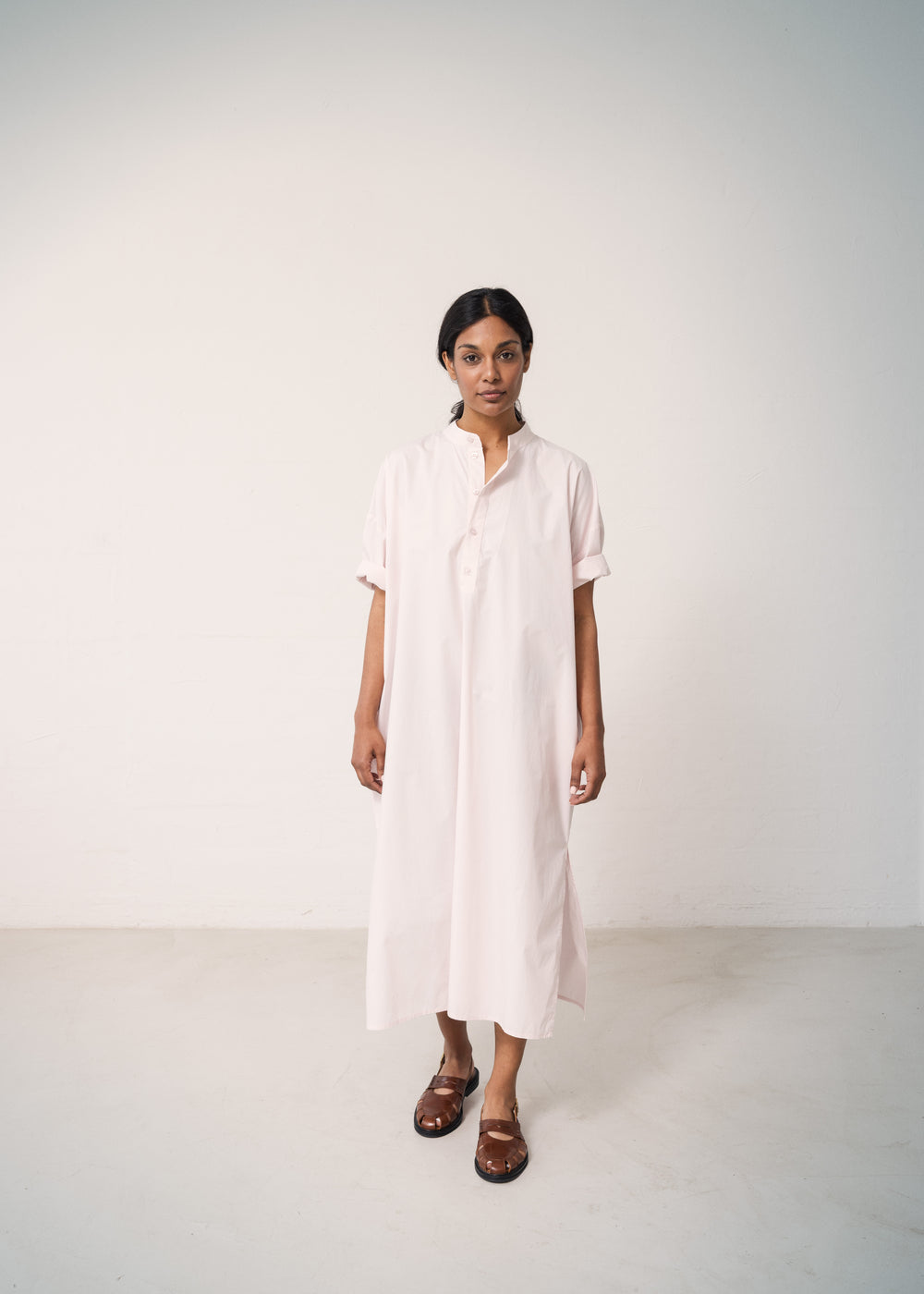 Woman wearing a bright red dress with a loose fit