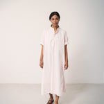 Woman wearing a bright red dress with a loose fit