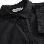 Short black shirt for women with a loose fit, classic collar.