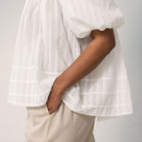 Woman in white shirt blouse in light cotton