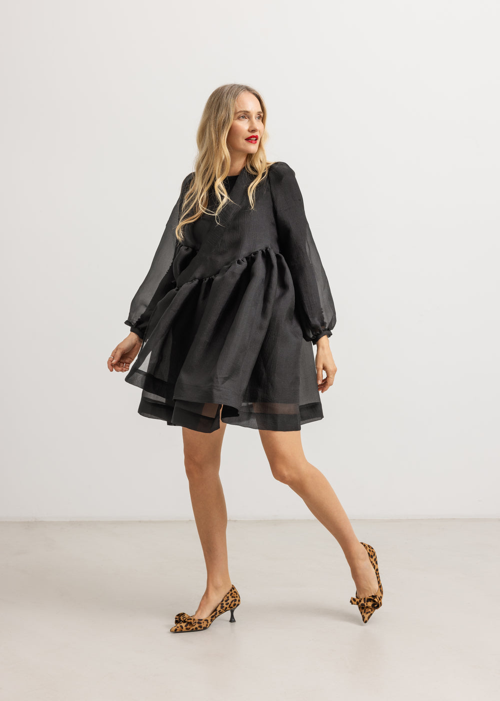 Short dress with long sleeves, gathered waist, and flared short skirt