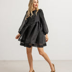 Short dress with long sleeves, gathered waist, and flared short skirt