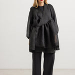 Black layered dress with long sleeves, elastic skirt, and round neckline