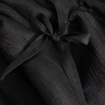 Black dress with bow detail at the neckline and gathered bodice