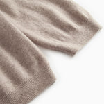 Knitted cuff and hem on a gray melange cardigan with ribbing.