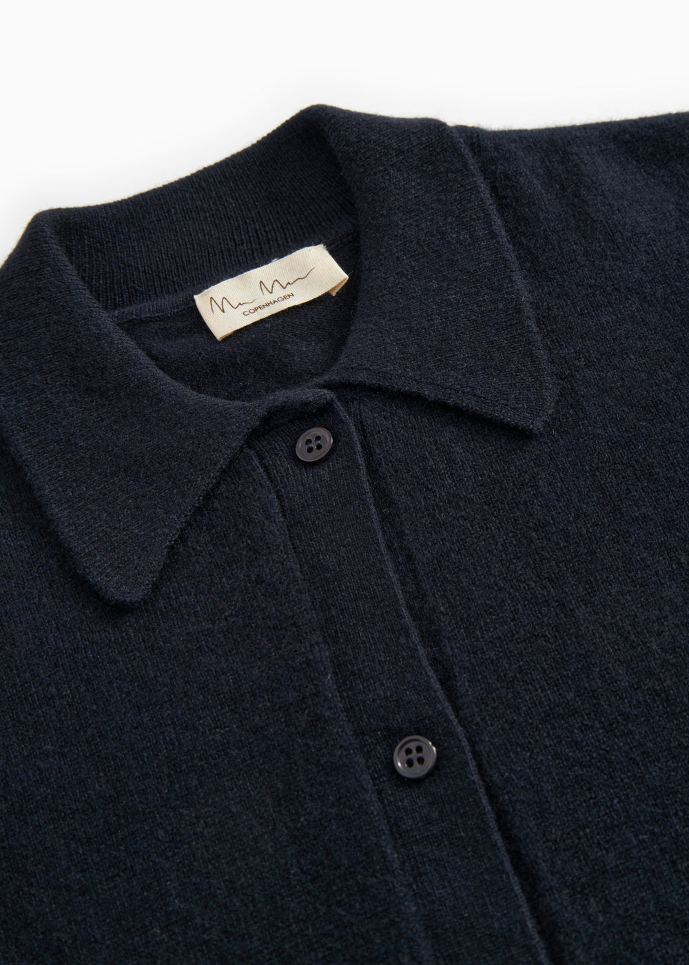 Kashmir cardigan with collar and button closure, close-up of fabric and brand
