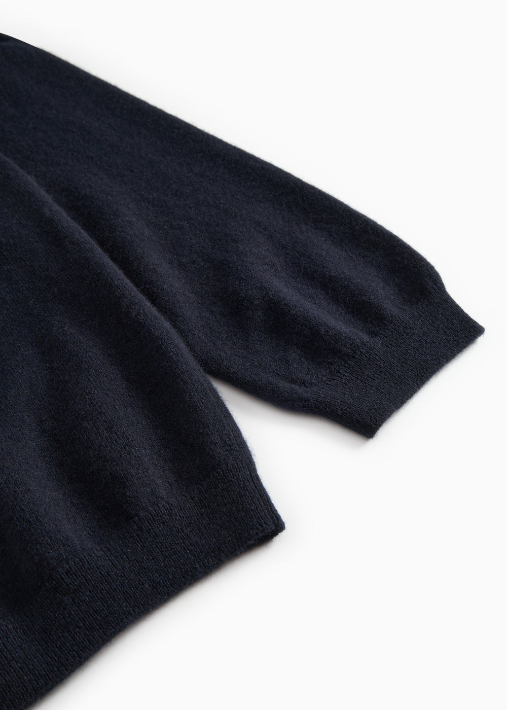 Dark indigo Kashmir cardigan with soft ribbed cuff detail.