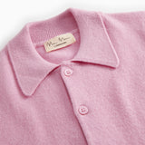 Pink polo shirt close to: collar and three buttons on the button placket