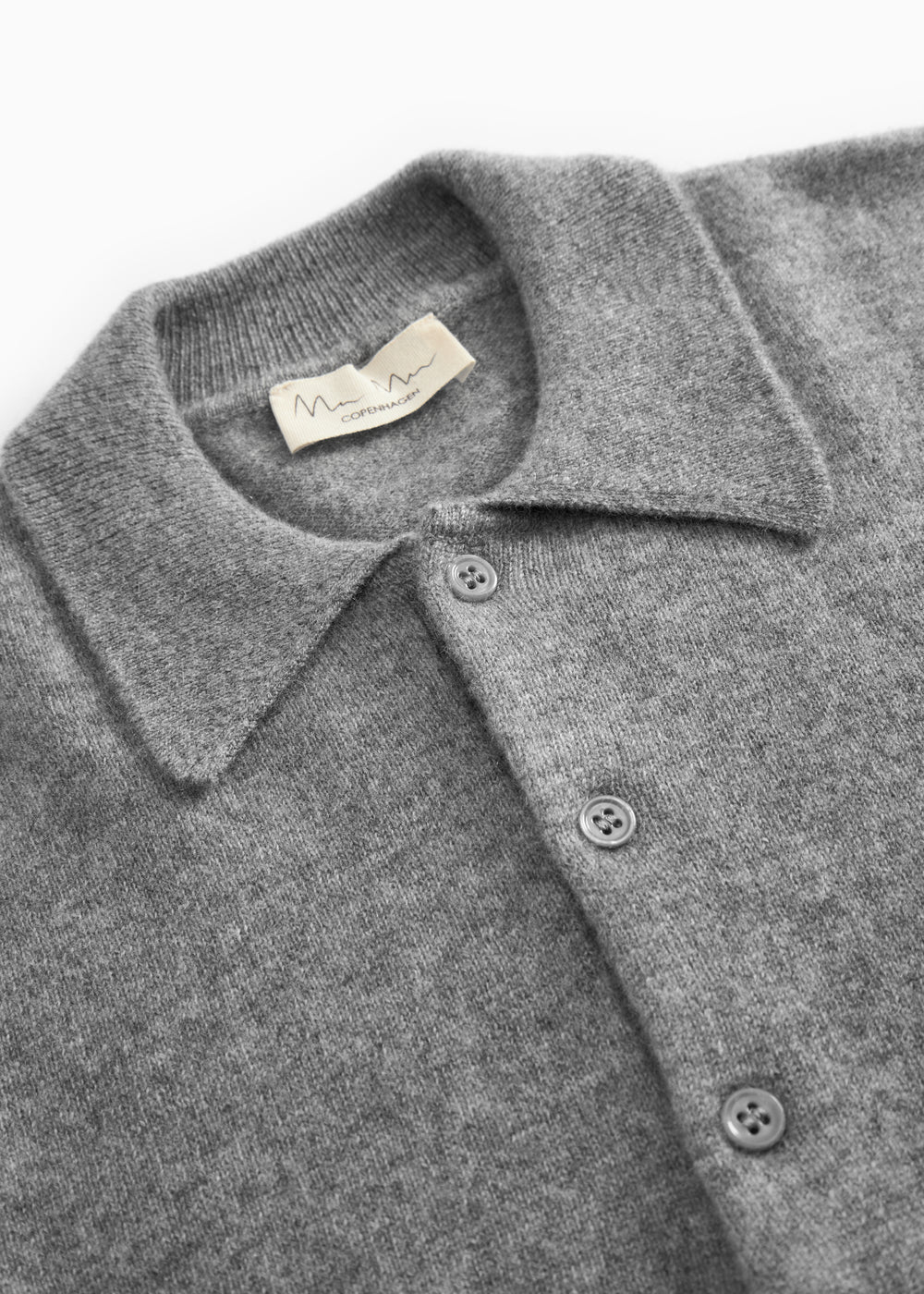 Gray melange cashmere polo: collar, button placket and brand badge at the neck.