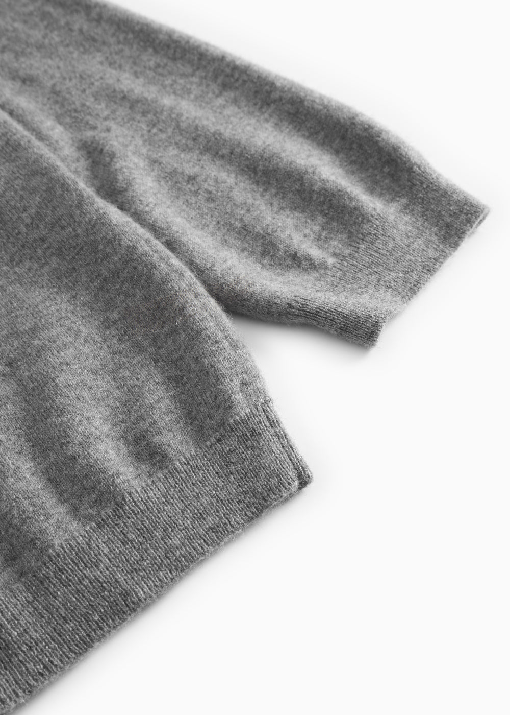 Gray blend knitted sleeve edge with ribbing on a Kashmir polo.