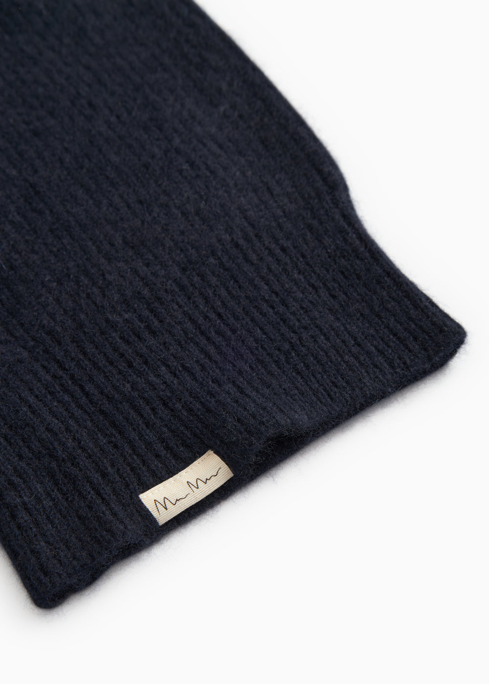 Kashmir hue in dark indigo with folded finish and label.