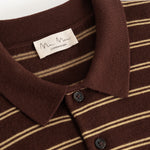 Black striped polo shirt with collar and button closure, plus ribbed trim at the neckline.