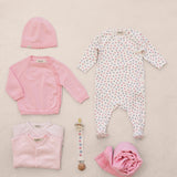 Baby sets with sparkles, red cardigan, hat, bodysuits, ribbons, and fabric flowers.