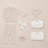 Red baby set with striped sweater, pants, body, and accessories