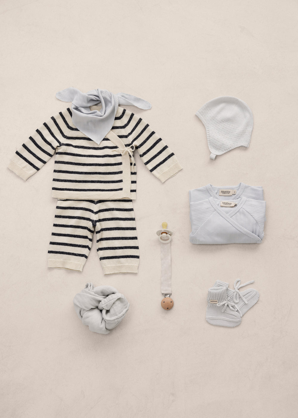 Baby sets with striped cardigan, body, hat, booties, and tassels.