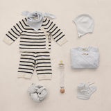 Baby sets with striped cardigan, body, hat, booties, and tassels.