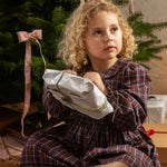 Dark checkered dress with long sleeves, waist bow, and gathered skirt